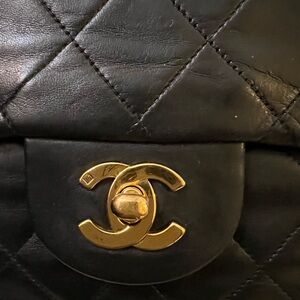 CHANEL Black Quilted Backpack with Gold Logo
